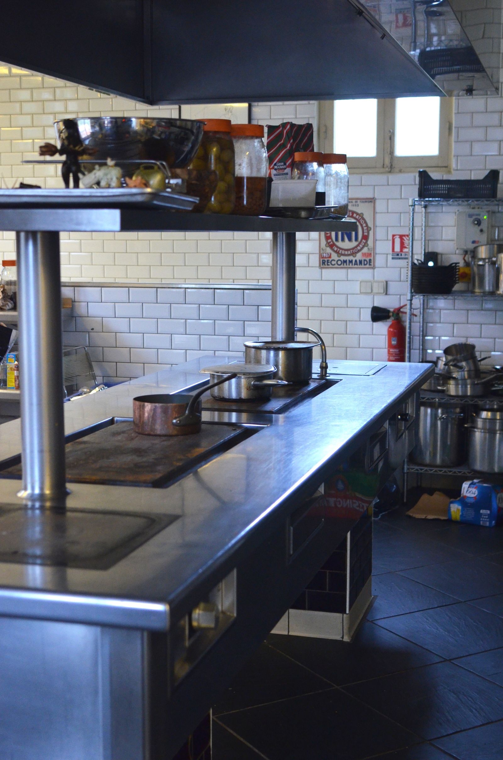 Stainless steel cooking equipment and work surfaces in a commercial kitchen